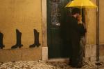 people standing under yellow umbrella